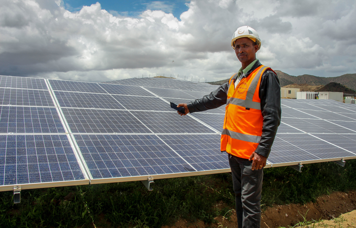 man in front of solar panels